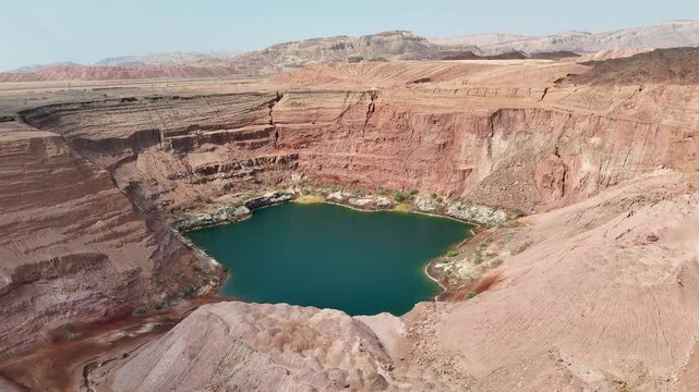 4K Drone Orbit Shot from Right to Left Over the Hidden Lake in Timna Park, Israel &ndash; Desert Aerial with Cliffs and Reflections