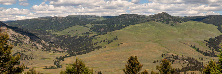 Rolling Hills Of Yellowstone Rise From The Valley Of The Hellroaring River