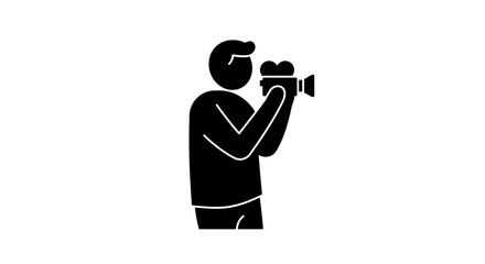 Silhouette of a person holding a vintage video camera, filming something in the distance.