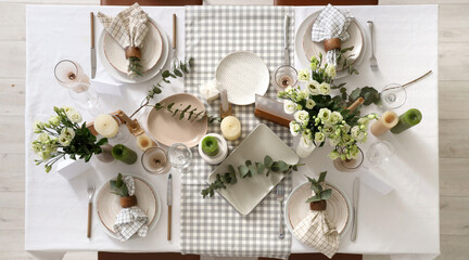 Beautiful table setting with eustoma flowers and eucalyptus for wedding celebration in room, top view © Pixel-Shot