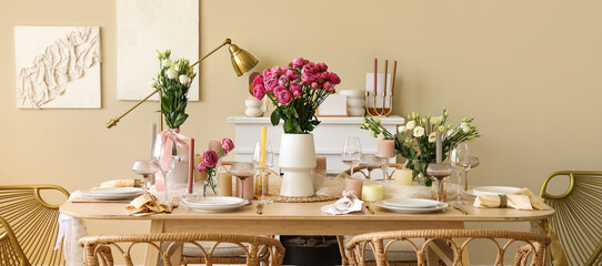Beautiful table setting with flowers and candles for wedding celebration in room
