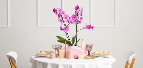 Beautiful table setting with orchid flower for wedding celebration in room
