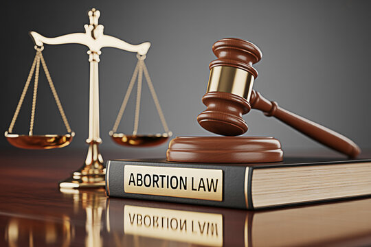 Abortion law book with gavel and scales of justice representing legal proceedings - Powered by Adobe