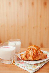 Milk and Croissants on the table as a delicious breakfast, vertical card with copy space	