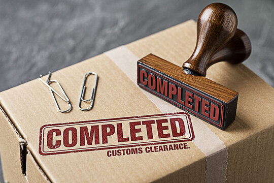 Completed customs clearance stamp on a cardboard box ready for international shipping