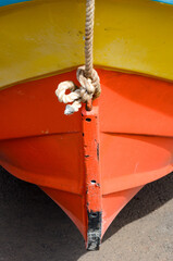 Colorful Boat Bow with Red, Yellow, Orange on Sandy Shore