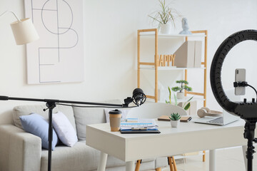 Blogger's workplace with gadgets, lamp and microphone in office