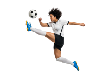 A determined female soccer player kicking a ball mid-air during a game. The athlete is wearing a soccer uniform and demonstrates skill and athleticism