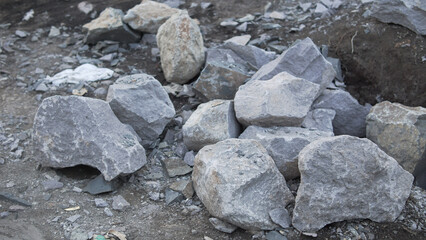 Rough Grey Stones and Broken Rocks on Earthy Ground