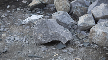 Rough Texture of Natural Gray Stones and Gravel Scattered on the Ground