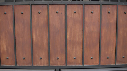 Fototapeta premium Rustic Brown Wood and Black Metal Panel with Decorative Studs