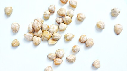 Top view of Candlenut seed or biji kemiri (Aleurites moluccanus). Isolated on white background with copy space. Suitable for design element, food article, or health concept.