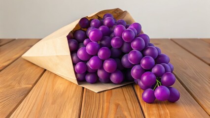 A bunch of purple grapes spilling from a paper cone onto a wooden surface.