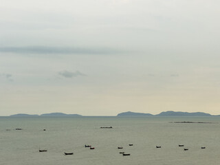 high angle seascape with boats and island moody sky