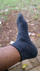 Foot in Dark Gray Sock Outdoors