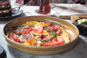 Delicious Omlet with tomatoes served in a plate 