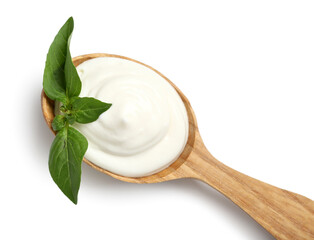 Wooden spoon with tasty sour cream and fresh basil on white background, top view