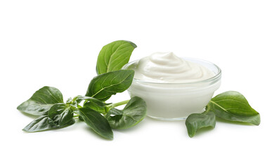 Bowl with tasty sour cream and fresh basil on white background