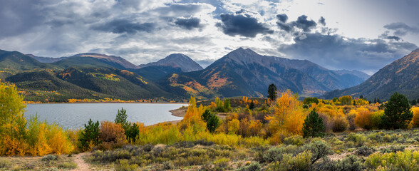 Panoramic view of Scenic Twin lakes recreation area in Colorado with colorful Aspen foliage in autumn.