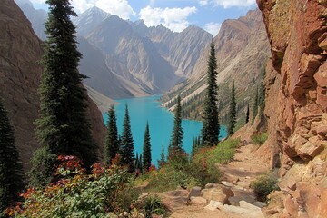 A breathtaking landscape showcasing a vibrant turquoise lake surrounded by towering mountains and evergreen trees under a clear blue sky.