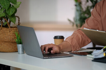Remote Work. Professional man using laptop for productivity in modern workspace.