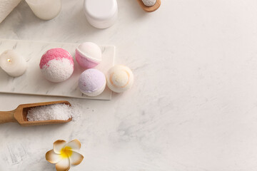 Composition with tray, bath bombs and scoop with sea salt on white grunge background