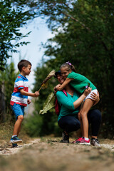 Fototapeta premium Mother and children enjoying a day outdoors, sharing joyful moments in nature.