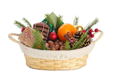Wicker gift basket with products and beautiful Christmas decor isolated on white background