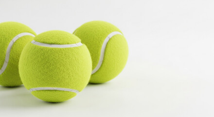 Pile of neon green tennis balls grouped together on white background, crisp equipment shot for retail catalogs, practice kits, club promotions and fitness marketing