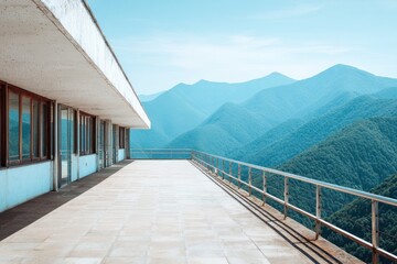 A spacious balcony, overlooking a serene mountain range, extends from a modern architectural structure, bathed in natural light.