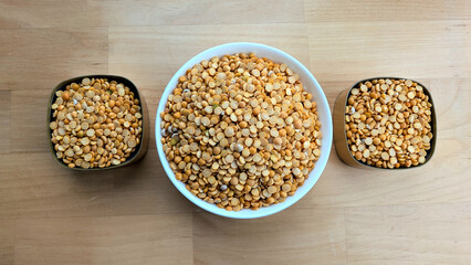 Yellow peas in white and gold bowls