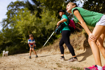 Fototapeta premium Family Enjoying a Refreshing Hiking Trail Adventure on a Summer Day