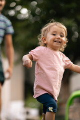 Fototapeta premium Happy child running outdoors in a playful and cheerful mood on a sunny evening