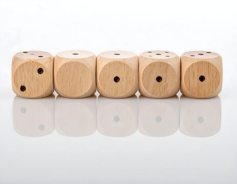 Row of five wooden dice with their reflection