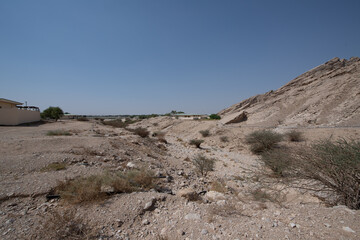 Scenic landscapes and mountain roads around Jebel Hafeet in Al Ain, United Arab Emirates, showing desert terrain, rocky hills, and winding routes under clear skies.