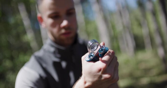 Demonstration of a hand exercise tool for strength training in a forest setting