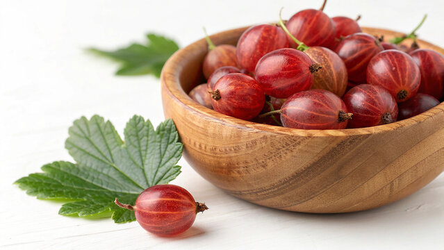 Red gooseberry in bowl on white tiled surface in white background