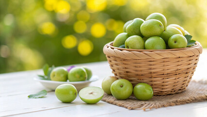 Fresh green jujube fruits in a basket on a wooden table in the garden on a sunny day