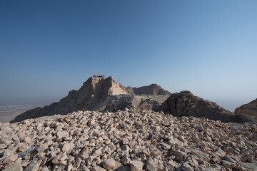 Scenic landscapes and mountain roads around Jebel Hafeet in Al Ain, United Arab Emirates, showing desert terrain, rocky hills, and winding routes under clear skies.