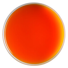 Vibrant orange liquid in a round glass bowl against a transparent background