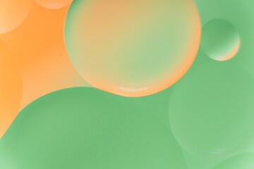 Vibrant Green and Orange Oil Bubbles Fluid Abstract Background