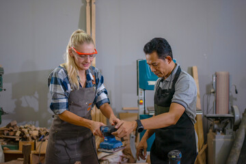 Carpenters are working together at workshop.