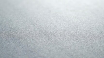 Close-up view of a subtly textured, lightly reflective surface with a muted gray tone, ideal for design backgrounds and subtle graphic applications.