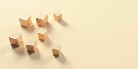 Wooden blocks arranged asymmetrically on a pale yellow background, showcasing simple geometric shapes and natural light casting soft shadows.