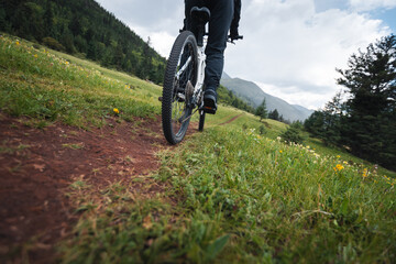 Riding mountain bike on grassland forest mountains