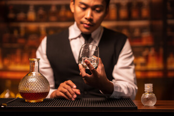 Bartender is pouring whiskey into a glass in a restaurant	