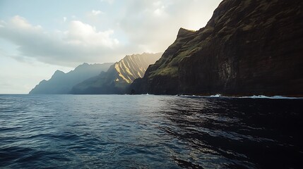 Dramatic cliffs meet ocean waves under cloudy skies during golden hour lighting conditions