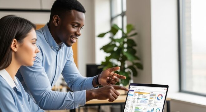 Diverse professionals collaborating on a data analytics project using laptop