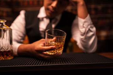 Bartender is pouring whiskey into a glass in a restaurant	