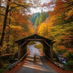 Idyllic Autumn Passage: Covered Bridge and Winding Road Through Vibrant Forest